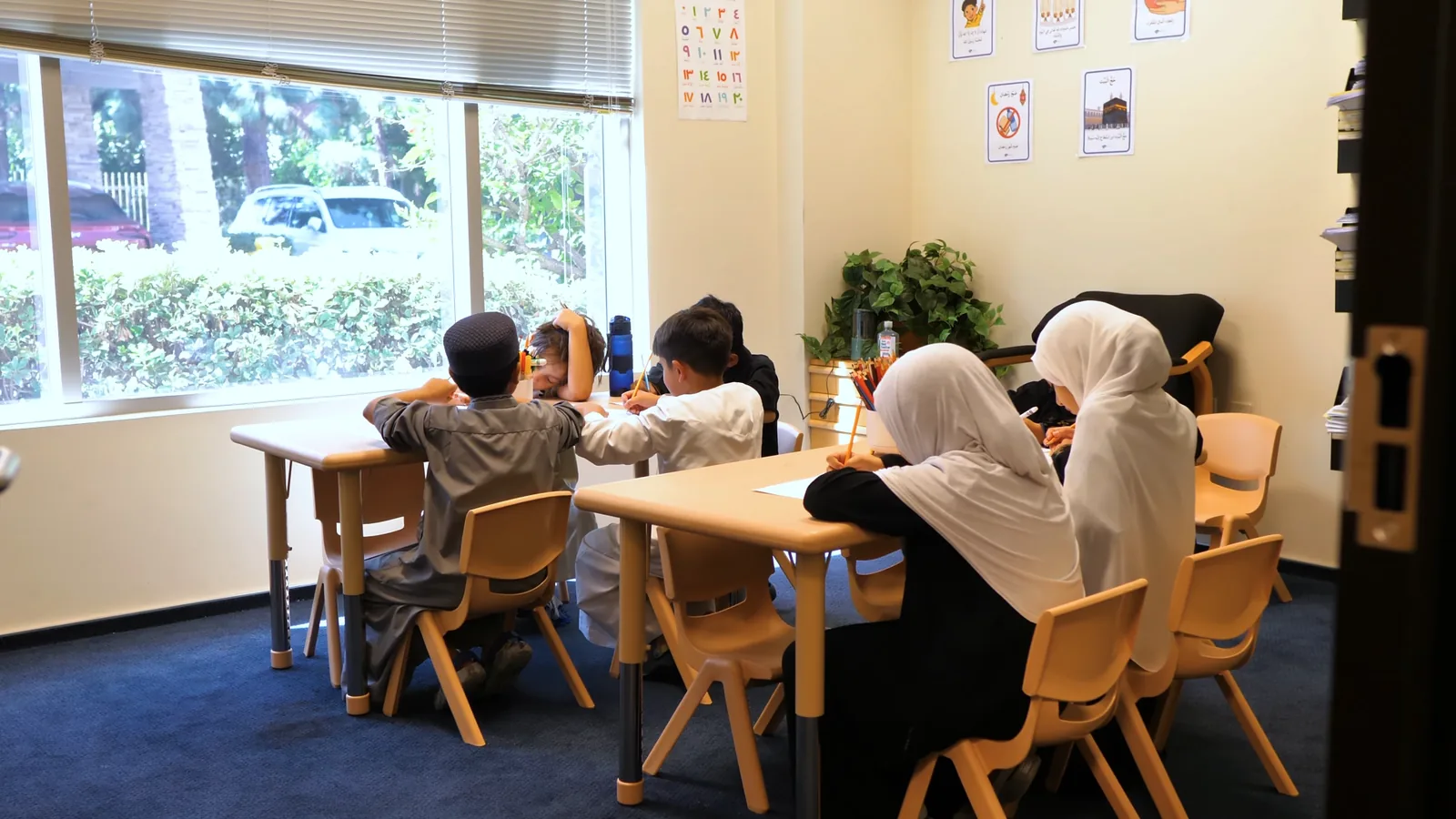 Students at Ayat Academy working together in a sunlit classroom